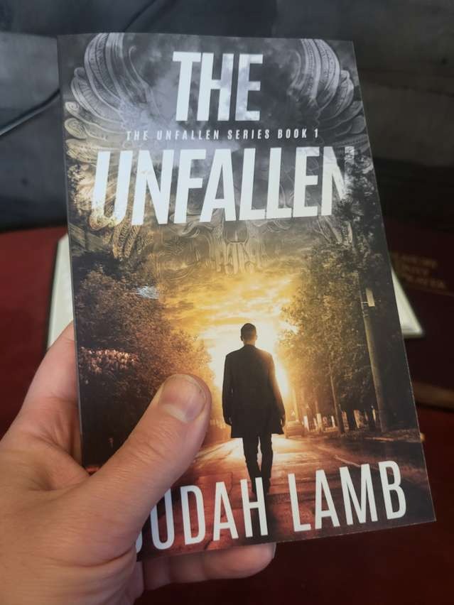The Unfallen paperback in hand